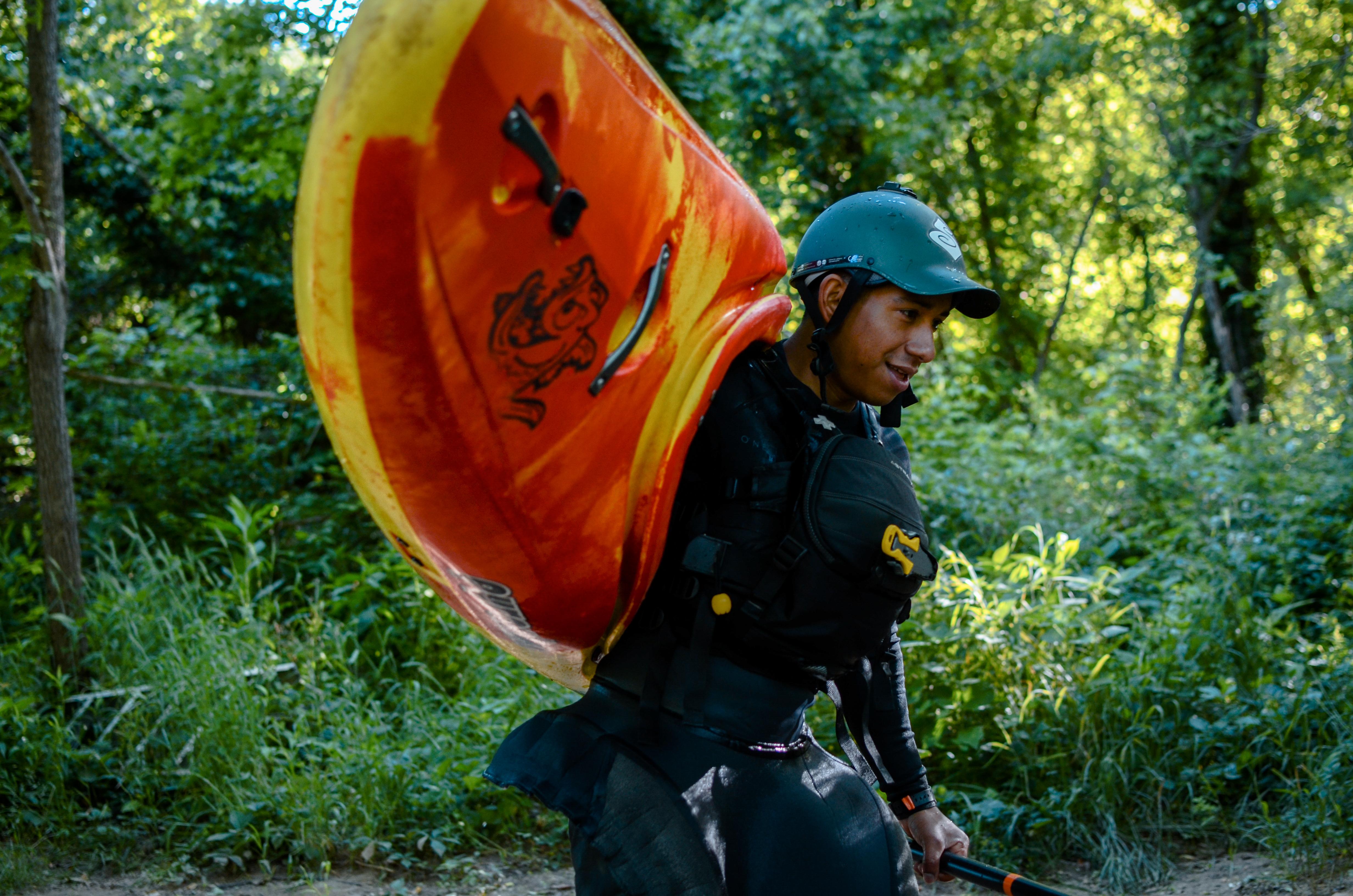 man carrying kayak