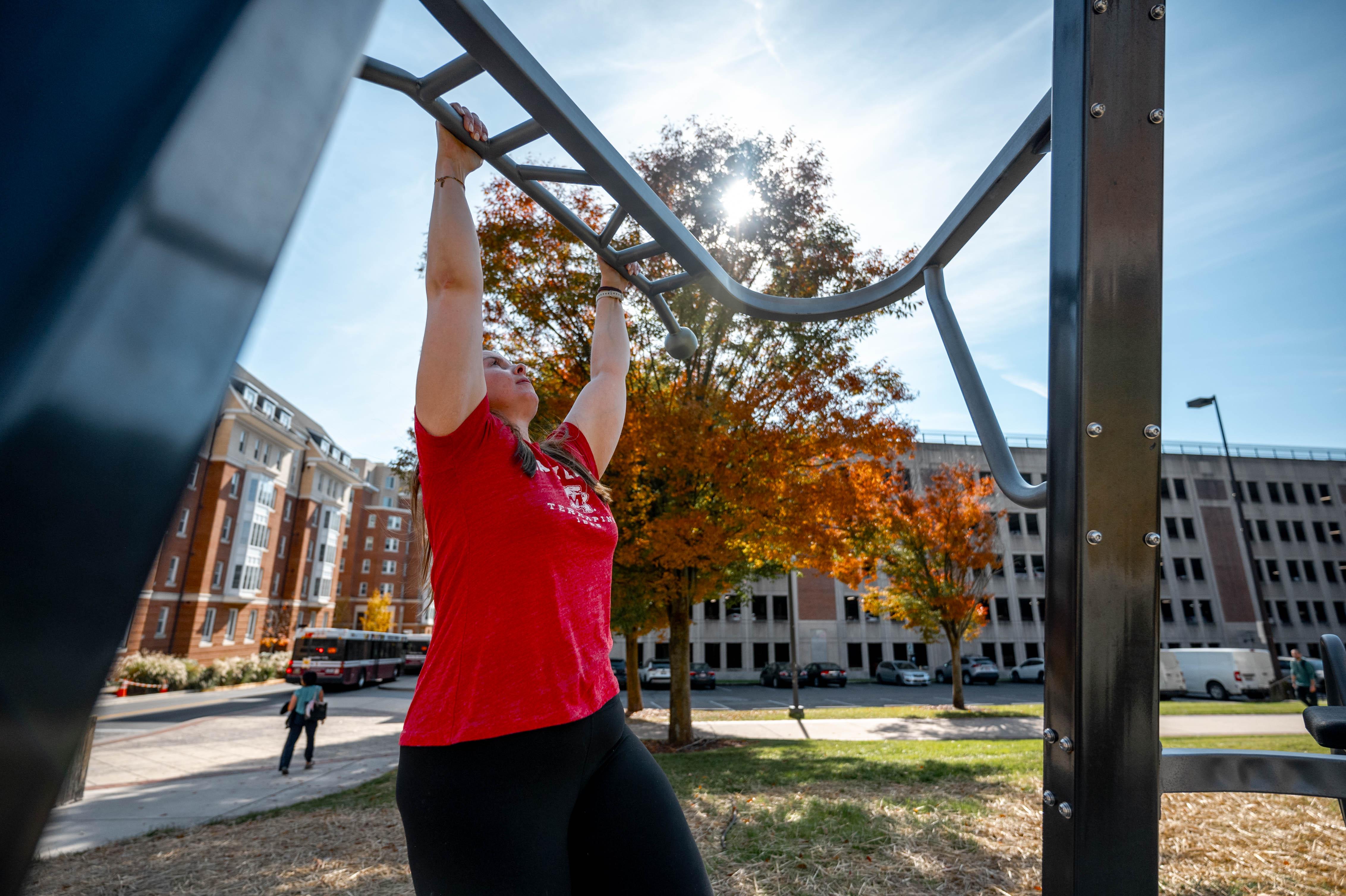 woman doing monkey bars